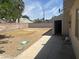 Backyard with rocks, building, and overgrown grass at 5424 Del Rey Ave, Las Vegas, NV 89146