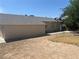 Backyard with building and overgrown grass at 5424 Del Rey Ave, Las Vegas, NV 89146