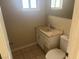 This bathroom has a toilet, sink, mirror, neutral color walls and tiled flooring at 5424 Del Rey Ave, Las Vegas, NV 89146
