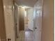 This hallway has neutral walls and flooring leading to other rooms in the home at 5424 Del Rey Ave, Las Vegas, NV 89146