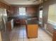 Spacious kitchen with wood cabinetry, an island, and stainless steel appliances at 5424 Del Rey Ave, Las Vegas, NV 89146