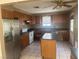 Spacious kitchen with wood cabinetry, an island, and stainless steel appliances at 5424 Del Rey Ave, Las Vegas, NV 89146