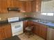 Kitchen featuring wood cabinets, granite countertops, and stainless steel appliances at 5424 Del Rey Ave, Las Vegas, NV 89146