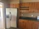 Kitchen featuring wood cabinets, granite countertops, and stainless steel refrigerator at 5424 Del Rey Ave, Las Vegas, NV 89146