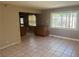 Inviting living room with tiled floors, a neutral palette, and ample natural light at 5424 Del Rey Ave, Las Vegas, NV 89146