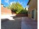 Home's backyard features a concrete patio, retaining walls, and low maintenance landscaping at 5445 Indian Cedar Dr, Las Vegas, NV 89135