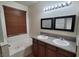A bathroom featuring double sinks, a bathtub, and a mirror at 5445 Indian Cedar Dr, Las Vegas, NV 89135