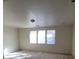 Spacious bedroom with ample light from three large windows and neutral carpeting at 5445 Indian Cedar Dr, Las Vegas, NV 89135