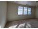 Bright bedroom featuring neutral walls, plush carpet, and multiple windows for lots of natural light at 5445 Indian Cedar Dr, Las Vegas, NV 89135