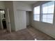 Bright bedroom featuring neutral walls, plush carpet, large windows, and a closet for ample storage at 5445 Indian Cedar Dr, Las Vegas, NV 89135