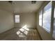 Spacious bedroom with neutral walls, hard flooring, and three windows for natural light at 5445 Indian Cedar Dr, Las Vegas, NV 89135