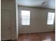 Bedroom featuring tile flooring, a door, and bright natural light from two windows at 5445 Indian Cedar Dr, Las Vegas, NV 89135