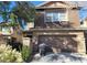 Two-story home with brown siding and an attached two-car garage at 5445 Indian Cedar Dr, Las Vegas, NV 89135