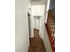 Hallway with tile floor, white walls, and access to multiple rooms and a staircase at 5445 Indian Cedar Dr, Las Vegas, NV 89135