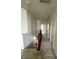 Hallway with carpet, white walls, and wooden railing, leading to multiple doors at 5445 Indian Cedar Dr, Las Vegas, NV 89135