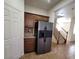 Kitchen has stainless steel refrigerator and dark wood cabinets with granite countertops at 5445 Indian Cedar Dr, Las Vegas, NV 89135