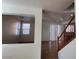Inviting living room with a staircase, tile floors, and connecting view into another room at 5445 Indian Cedar Dr, Las Vegas, NV 89135