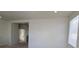 Spacious living room with neutral walls and access to other parts of the house at 5445 Indian Cedar Dr, Las Vegas, NV 89135