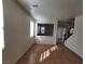 Living room showcasing tile flooring, a wooden staircase, and bright natural light at 5445 Indian Cedar Dr, Las Vegas, NV 89135