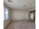 Open living room area featuring neutral walls, carpet, and multiple windows offering lots of natural light at 5445 Indian Cedar Dr, Las Vegas, NV 89135