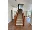 Carpeted stairs with wooden railing lead to the upper level of the home at 5445 Indian Cedar Dr, Las Vegas, NV 89135