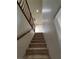 Carpeted stairs with wood railing lead to the second floor at 5445 Indian Cedar Dr, Las Vegas, NV 89135