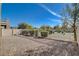 Spacious backyard showcasing a low-maintenance gravel area with fencing for privacy at 5524 Overlook Valley St, North Las Vegas, NV 89081