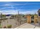 Relaxing balcony view offers a tranquil scene of landscaped grounds and a vibrant blue sky at 5524 Overlook Valley St, North Las Vegas, NV 89081