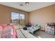 Bright bedroom with a sliding glass door to balcony and fun play area at 5524 Overlook Valley St, North Las Vegas, NV 89081