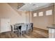 Dining area with a modern table and gray chairs, with hardwood floors and neutral walls at 5524 Overlook Valley St, North Las Vegas, NV 89081