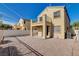Exterior view of the home with an open patio and second-story balcony, set in a landscaped backyard at 5524 Overlook Valley St, North Las Vegas, NV 89081