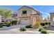 Inviting two-story home featuring a two-car garage, balcony and desert landscaping at 5524 Overlook Valley St, North Las Vegas, NV 89081