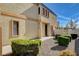 Landscaped front yard leading to a home featuring a charming exterior with a light tan facade at 5524 Overlook Valley St, North Las Vegas, NV 89081