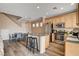 Bright kitchen with stainless steel appliances, wooden cabinets, and island with barstool seating at 5524 Overlook Valley St, North Las Vegas, NV 89081