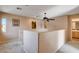 Carpeted landing featuring neutral walls, a ceiling fan, and access to multiple rooms at 5524 Overlook Valley St, North Las Vegas, NV 89081