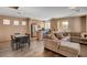 Open-concept living area with modern furnishings, seamlessly connecting the kitchen, dining, and lounge spaces at 5524 Overlook Valley St, North Las Vegas, NV 89081