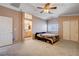 Spacious primary bedroom showcasing a ceiling fan, neutral walls, and an ensuite bathroom at 5524 Overlook Valley St, North Las Vegas, NV 89081