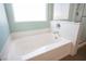 A bathtub with a tiled shower and chrome fixtures sits in a clean, bright bathroom at 5638 Jelsma Ave, Las Vegas, NV 89141