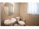 Small bathroom featuring a pedestal sink, toilet, and a round mirror at 5638 Jelsma Ave, Las Vegas, NV 89141