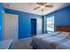 A Primary bedroom boasts carpet floors, blue walls, and natural light from the window at 5638 Jelsma Ave, Las Vegas, NV 89141