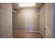 An empty walk-in closet with wire shelving and neutral-toned walls with carpeted floors at 5638 Jelsma Ave, Las Vegas, NV 89141