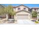 Two-story home with a two-car garage, desert landscaping and inviting front entrance at 5638 Jelsma Ave, Las Vegas, NV 89141