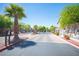 Community entrance with palm tree, brick paved drive and black metal gates at 5638 Jelsma Ave, Las Vegas, NV 89141