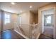 Upstairs hallway featuring wood-look flooring, neutral walls, and a white banister at 5638 Jelsma Ave, Las Vegas, NV 89141