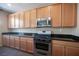 Kitchen features wood cabinets, stainless steel appliances, and granite countertops at 5638 Jelsma Ave, Las Vegas, NV 89141