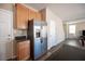 Eat-in kitchen featuring stainless steel refrigerator, granite countertops, and wooden cabinets at 5638 Jelsma Ave, Las Vegas, NV 89141