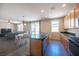 Kitchen features wood cabinets, stainless steel appliances, granite countertops, and open layout at 5638 Jelsma Ave, Las Vegas, NV 89141