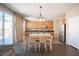 Bright eat-in kitchen features wood cabinets, stainless steel appliances, and sliding door to backyard at 5638 Jelsma Ave, Las Vegas, NV 89141