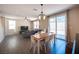 Open-concept living area features laminate flooring, neutral paint, and sliding doors to outdoor living at 5638 Jelsma Ave, Las Vegas, NV 89141
