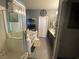 Bathroom featuring tub/shower combo with glass doors, double sink vanity, and gray walls at 5832 Elphin Ct, North Las Vegas, NV 89031